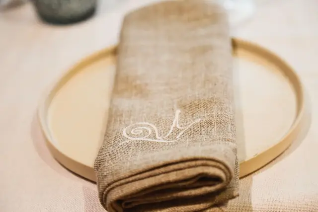 Detalle de la mesa de banquete con la servilleta bordada